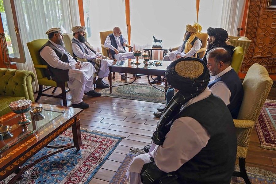 This handout photo released by the Arabic Twitter account of the "Islamic Emirate of Afghanistan" on 18 August 2021 shows a Taliban delegation led by the head of the negotiating team Anas Haqqani (centre right) meeting with former Afghan government officials including former president Hamid Karzai (centre left) at an unspecified location in Afghanistan. (Islamic Emirate of Afghanistan/AFP)