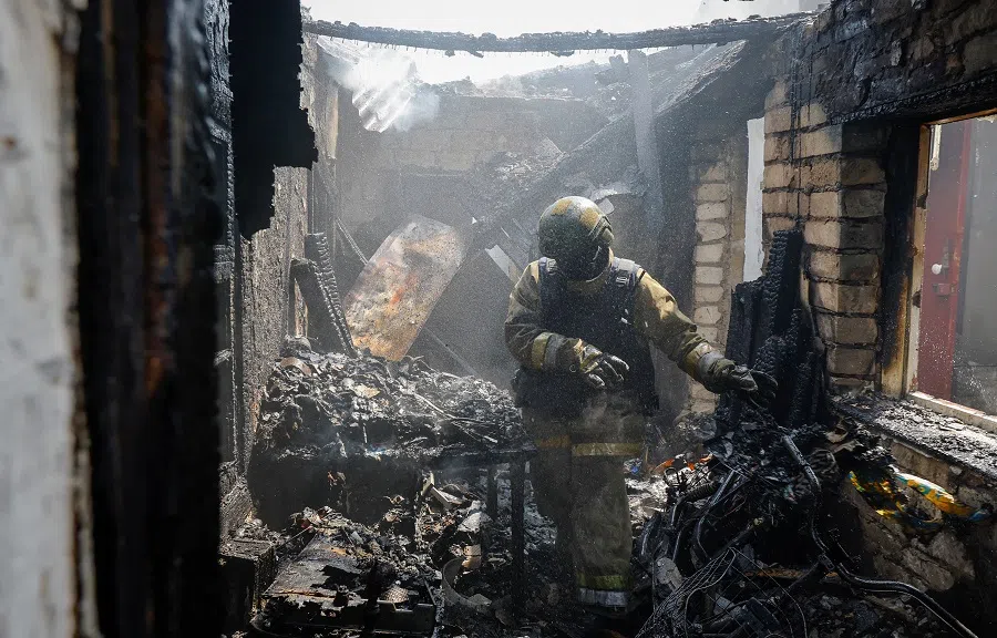 A firefighter works amid debris of a destroyed house in a residential area in Makiivka (Makeyevka), Donetsk region, Russian-controlled Ukraine, on 22 May 2024. (Alexander Ermochenko/Reuters)