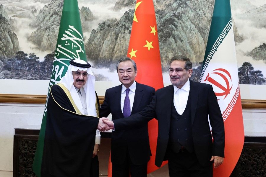 Wang Yi (centre), a member of the Political Bureau of the Communist Party of China (CPC) Central Committee and director of the Office of the Central Foreign Affairs Commission, Ali Shamkhani (right), the secretary of Iran's Supreme National Security Council, and Minister of State and national security adviser of Saudi Arabia Musaad bin Mohammed Al Aiban (left) pose for pictures during a meeting in Beijing, China, 10 March 2023. (China Daily via Reuters)