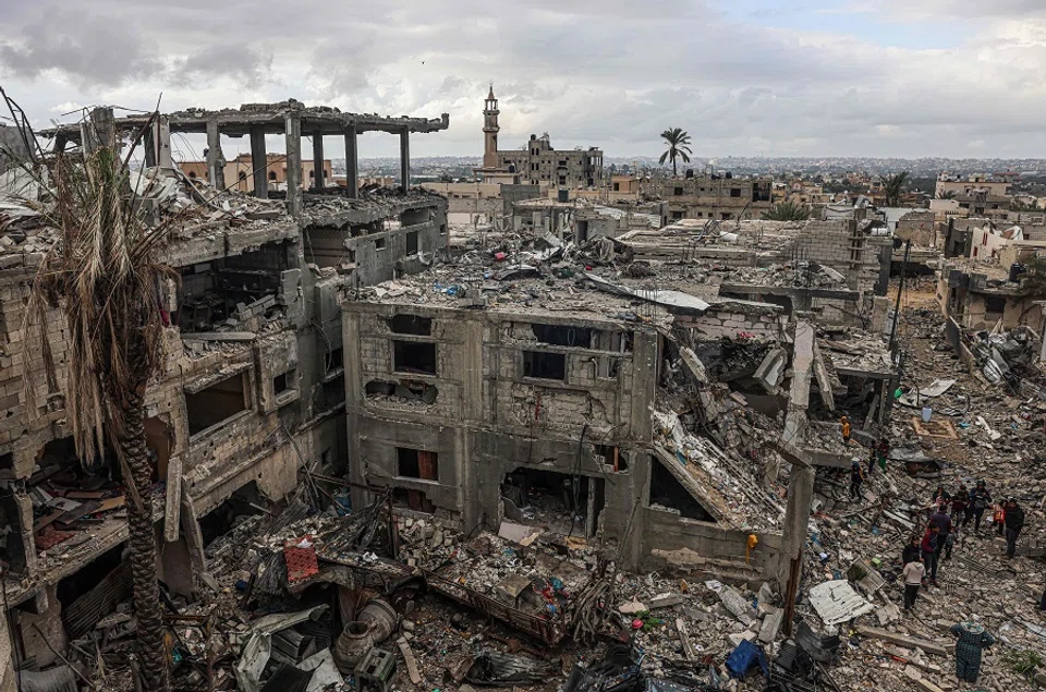 Palestinians inspect the destruction caused by Israeli strikes on their homes in the village of Khuzaa, east of Khan Yunis near the border fence between Israel and the southern Gaza Strip on 27 November 2023, amid a truce in battles between Israel and Hamas. (Said Khatib/AFP)