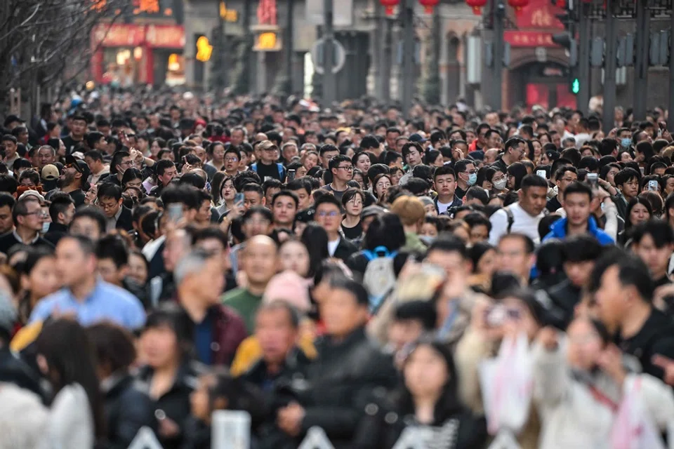 People visit a pedestrian street on the Bund in Shanghai, China, on 14 February 2024. (Hector Retamal/AFP)