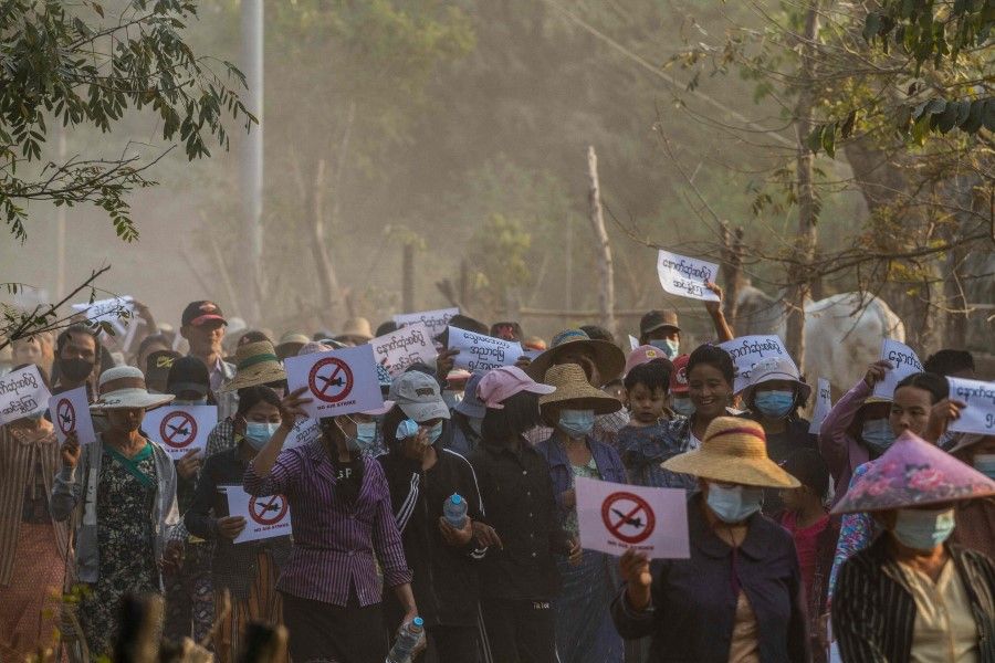 This photo taken on 13 February 2022, shows protesters marching during a demonstration against the military coup in Ayadaw Township, in Monywa District in the Sagaing Division of Myanmar. (AFP)