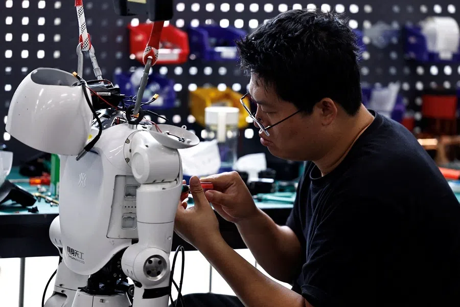 An engineer works on a Tiangong Omni humanoid robot in the research and testing area of the Beijing Humanoid Robot Innovation Center, also known as X-Humanoid, in Beijing, China, 4 September 2026.