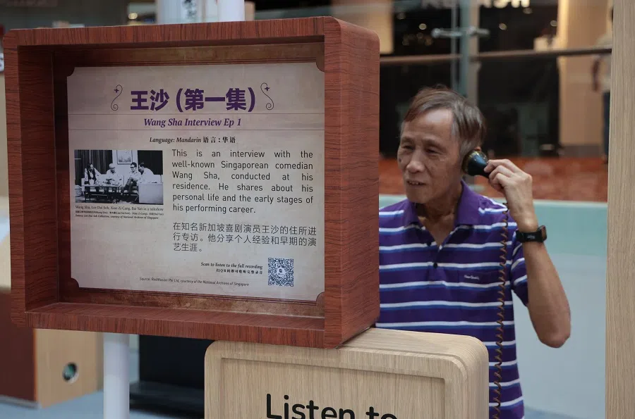 A man listens to a recording at a retro-themed Node, modelled after a radio studio, featuring a selection of Mandarin and Chinese dialect Rediffusion programmes and photographs from the National Archives of Singapore (NAS) collection.