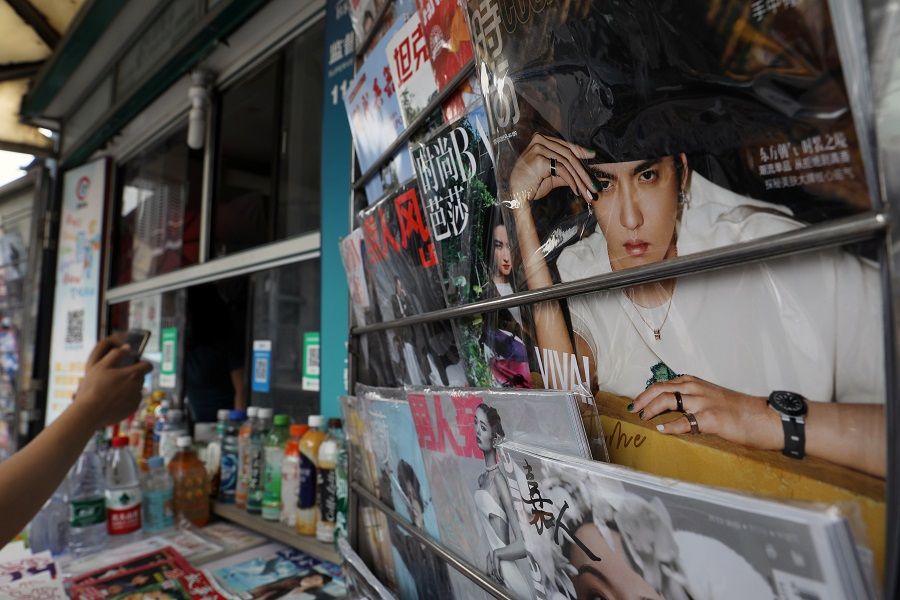 Singer-actor Kris Wu is seen on the cover of a fashion magazine at a newsstand in Beijing, China, 20 July 2021. (Tingshu Wang/Reuters)