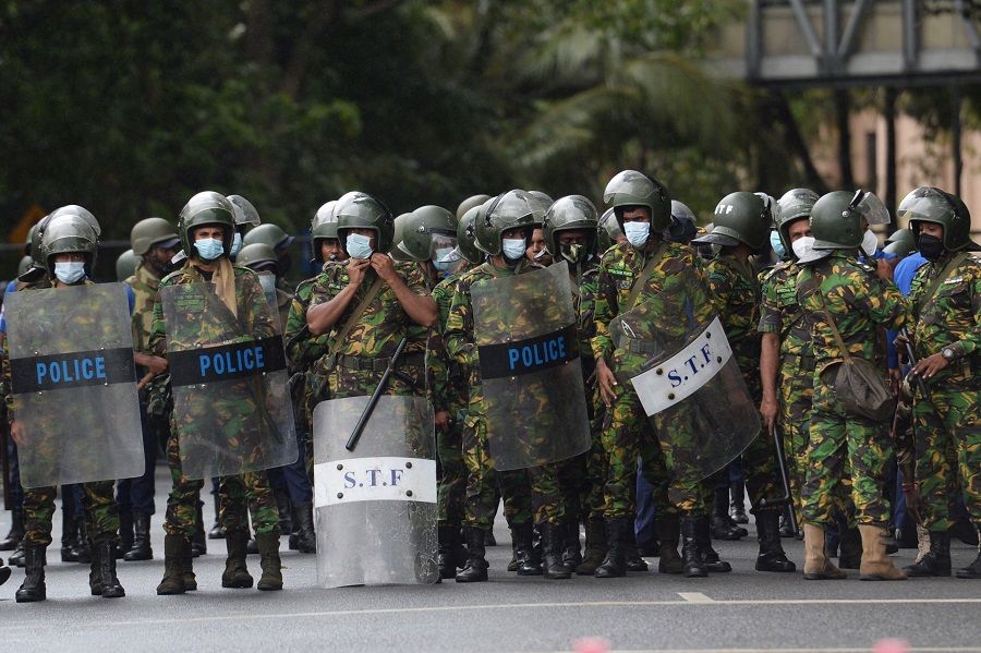 Police special task force personnel stand guard as demonstrators (not pictured) take part in a protest march against Sri Lankan President Ranil Wickremesinghe towards the Presidential Secretariat office, in Colombo, Sri Lanka, on 22 July 2022. (Arun Sankar/AFP)