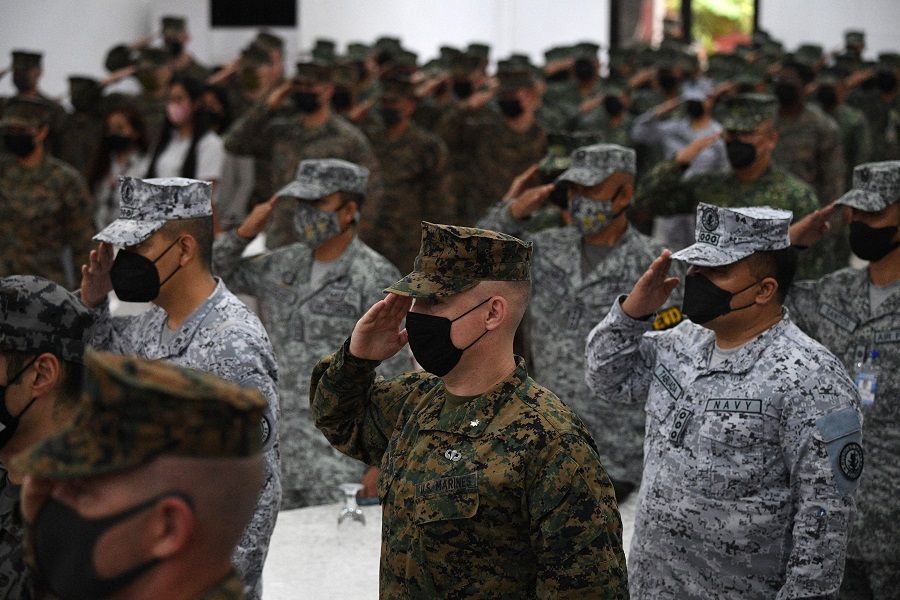 Philippine and US marines salute while their national anthems are played during the opening ceremony of "Kamandag" (cooperation of the warriors of the sea), a joint military exercise between US and Philippine marines at the Philippine marines headquarters in Taguig, Manila, Philippines, on 3 October 2022. (Ted Aljibe/AFP)