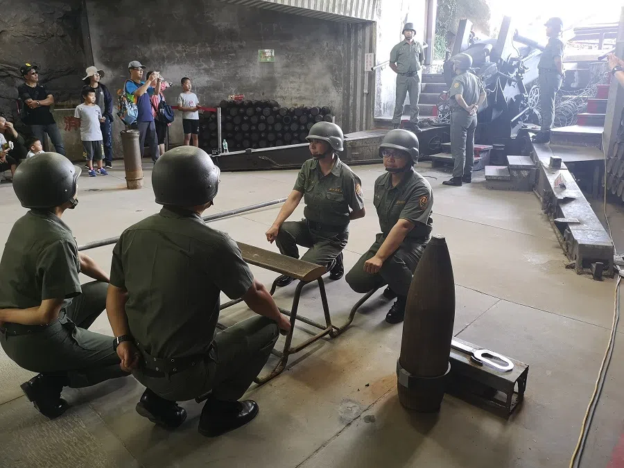 Soldiers prepare to fire a cannon.