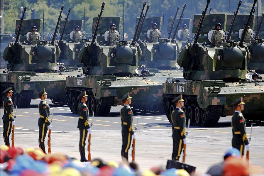 China's People's Liberation Army (PLA) soldiers on their armoured vehicles equipped with anti-aircraft artillery roll to Tiananmen Square during the military parade marking the 70th anniversary of the end of World War II, in Beijing, China, 3 September 2015. (Damir Sagolj/File Photo/Reuters)
