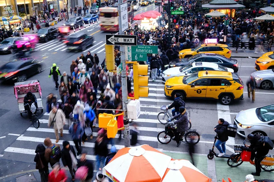 People walk along Sixth Avenue and 42nd street in the Manhattan borough of New York City on 13 December 2025. (Charly Triballeau/AFP)