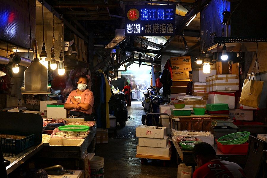 A fish seller in Taipei, Taiwan, 4 August 2022. (Ann Wang/Reuters)