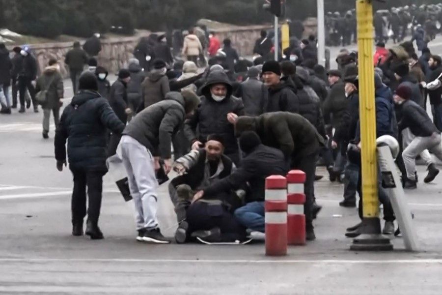 A frame grab taken on 6 January 2022 from an AFPTV video made on 5 January 2022, shows protesters clashing with Kazakstan's security forces during a demonstration in the country largest city Almaty as unprecedented unrest in the Central Asian nation spins out of control due to a hike in energy prices. (Alexander Platonov/AFPTV/AFP)
