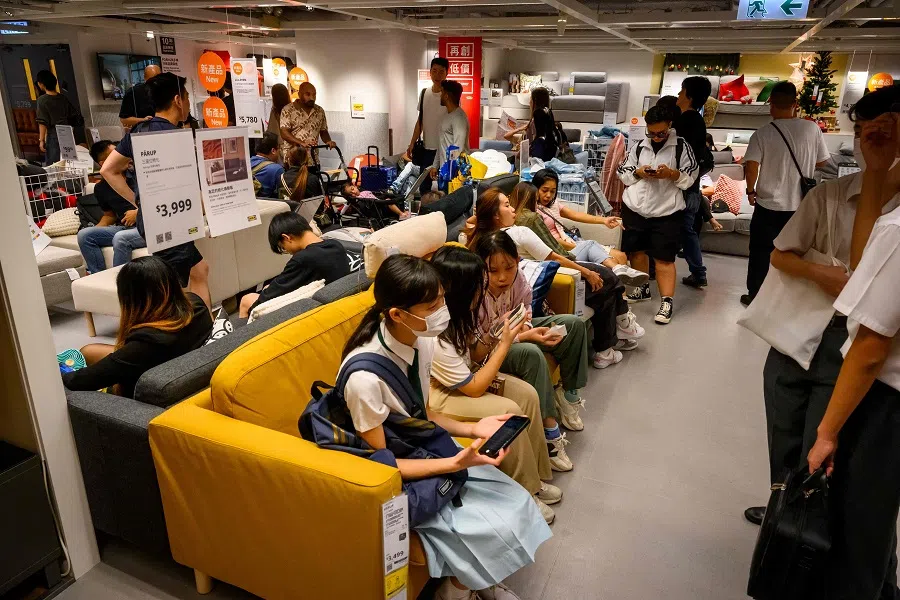 People relax on the sofas at IKEA store in the shopping district of Causeway Bay in Hong Kong on 3 November 2024. (Mladen Antonov/AFP)