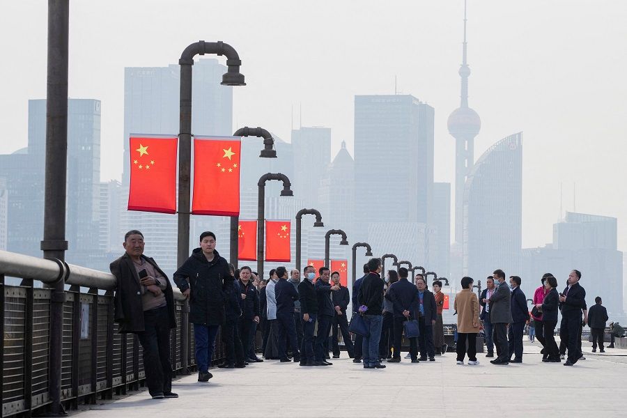 People visit a riverside in front of the Lujiazui financial district in Shanghai, China, 7 March 2023. (Aly Song/Reuters)