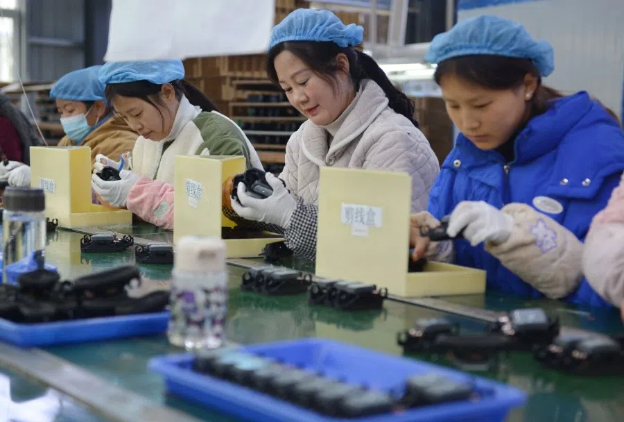 An assembly line producing speakers at a factory in Fuyang city, in China's eastern Anhui province on 30 November 2022. (AFP)