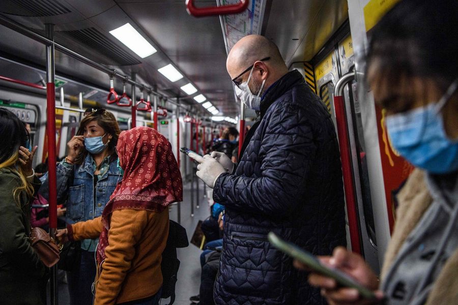 Hong Konger's awareness of virus outbreaks has greatly increased since the 2003 SARS epidemic. Pictured here are passengers wearing face masks while travelling on a MTR in Hong Kong on 27 January 2020 as a preventative measure following the coronavirus outbreak which began in the Chinese city of Wuhan. (Anthony Wallace/AFP)