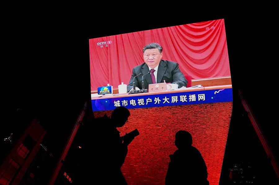 In this file photo taken on 11 November 2021, China's President Xi Jinping is seen on a screen during an evening news programme at a mall in Beijing, China. (Noel Celis/AFP)