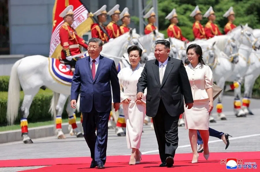 This picture taken on 8 June 2026 and released by North Korea's official Korean Central News Agency (KCNA) on 9 June 2026 shows North Korean leader Kim Jong Un with his wife Ri Sol Ju and China's President Xi Jinping and his wife Peng Liyuan attending a welcoming ceremony at Kim Il Sung Square in Pyongyang.