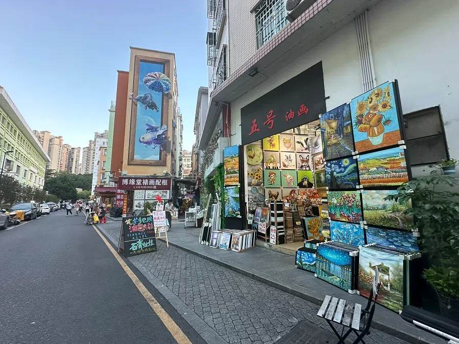 Paintings displayed outside a workshop in Dafen.