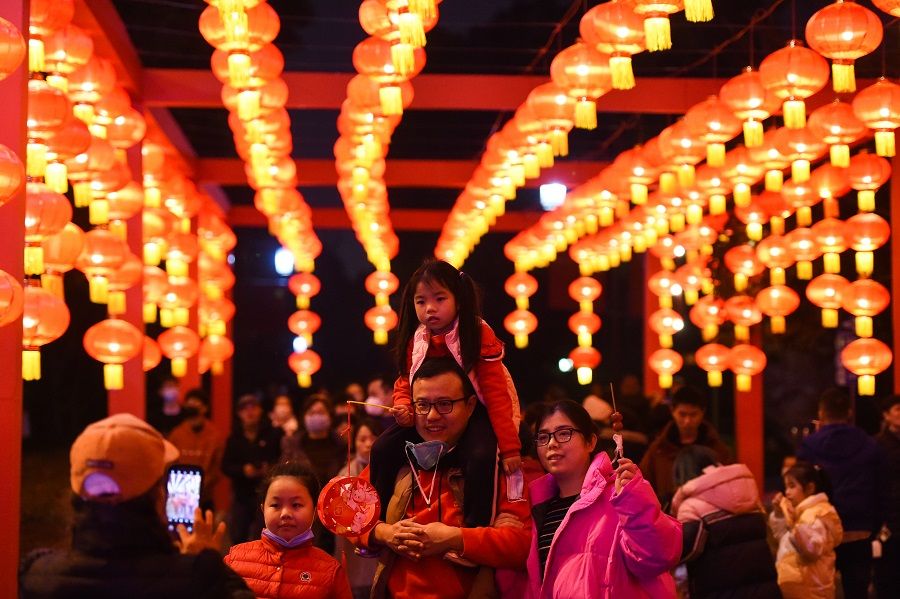 People pose for photographs under lanterns in Hong'en Temple Forest Park, Chongqing, China, 3 February 2023. (CNS)