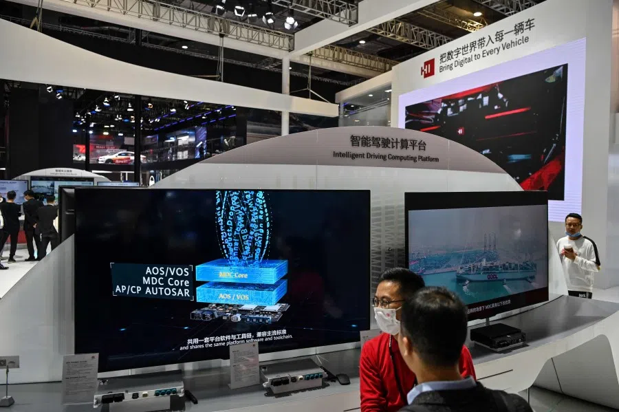People visit a Huawei stand during the 19th Shanghai International Automobile Industry Exhibition in Shanghai on 20 April 2021 (Hector Retamal/AFP)