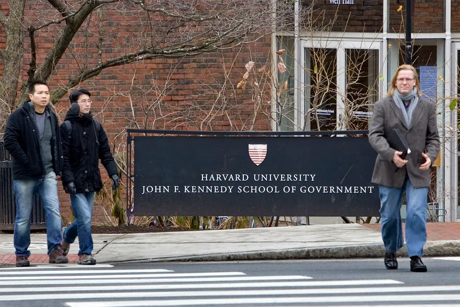 Pedestrians walk past the Harvard University John F. Kennedy School of Government in Cambridge, Massachusetts, US, on 15 December 2009. (Michael Fein/Bloomberg)