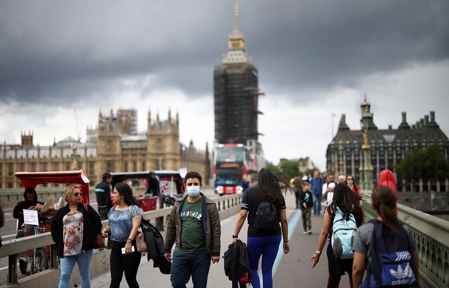 People walk over Westminster Bridge in London, UK, 4 July 2021. (Henry Nicholls/File Photo/Reuters)