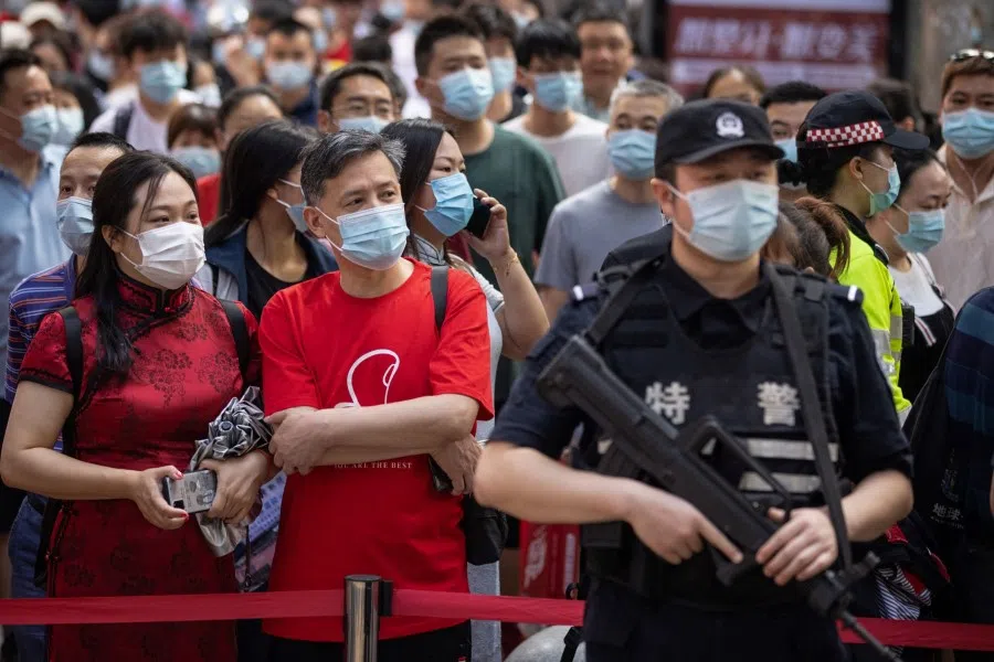 Parents wait outside a school as students arrive to take the gaokao in Wuhan, Hubei province on 7 June 2021. (STR/AFP)