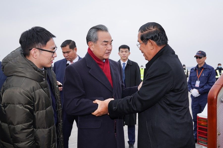 Chinese State Councilor and Foreign Minister Wang Yi welcomes Cambodian Prime Minister Hun Sen as he arrives at the Beijing Capital International Airport in Beijing. (Xinhua)