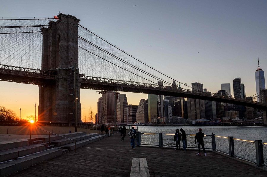 People take pictures at Brooklyn Bridge Park during sunset on 26 January 2022 in New York City, US. (Angela Weiss/AFP)