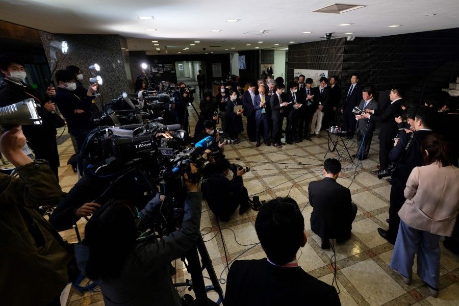 Japan's Foreign Minister Toshimitsu Motegi (R) speaks to members of the media at the foreign ministry in Tokyo, 5 March 2020. A state visit by Chinese President Xi Jinping was postponed. (Kazuhiro Nogi/AFP)