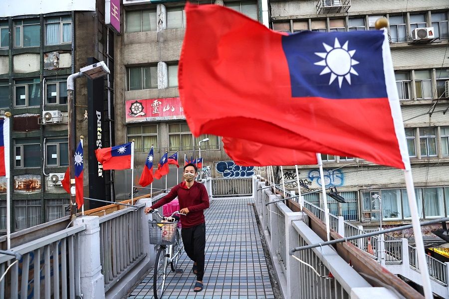 A man walks on an overpass decorated with Taiwan flags to celebrate the upcoming Double Tenth Day in Taipei, Taiwan, 7 October 2021. (Ann Wang/Reuters)