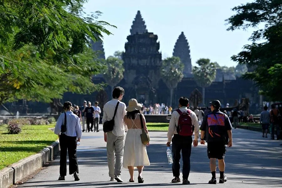 This photo taken on 18 December 2025 shows tourists in front of the Angkor Wat temple in Siem Reap province. (Tang Chhin Sothy/AFP)