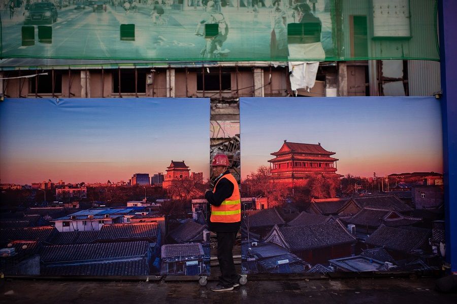 A worker leaves a construction site in Beijing on 28 October 2020. (Nicolas Asfouri/AFP)