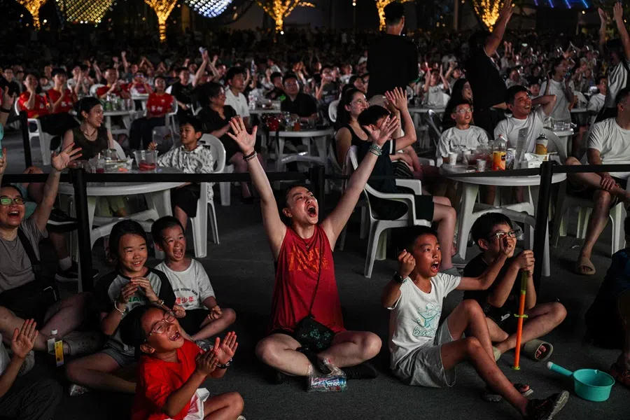 Fans celebrate a goal during the amateur league football match between Suzhou and Zhenjiang in the Shishan cultural square in Suzhou, in eastern China’s Jiangsu province on 20 July 2025. (Hector Retamal/AFP)