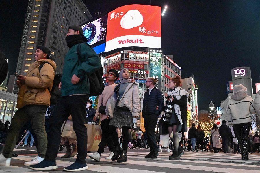 People walk across Shibuya Crossing in Tokyo, Japan, on 31 December 2023. (Richard A. Brooks/AFP)