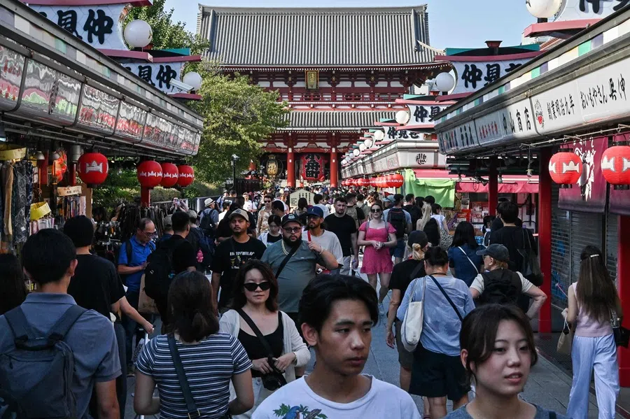 People walk past shops during a visit to Sensoji Temple in the Asakusa district of Tokyo on 16 September 2025. (Richard A. Brooks/AFP)