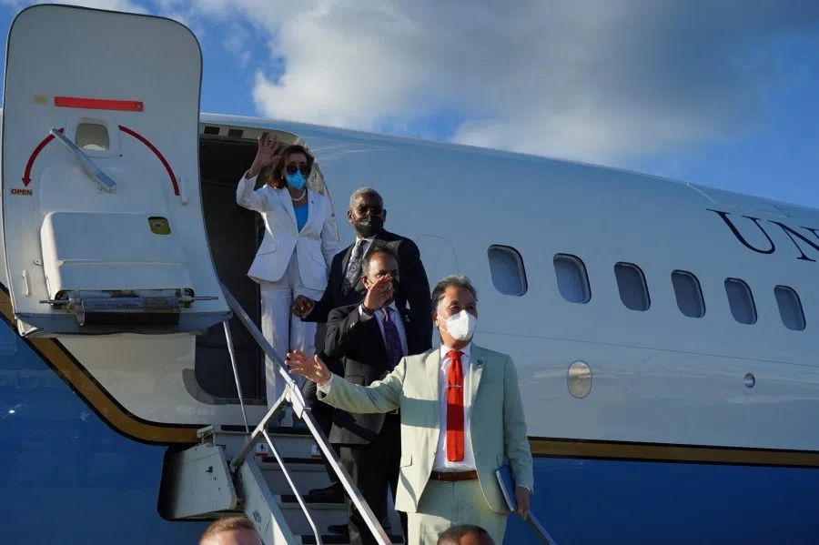 US House of Representatives Speaker Nancy Pelosi waves with other members of the delegation as they board a plane before leaving Taipei Songshan Airport, in Taipei, Taiwan, 3 August 2022. (Taiwan Ministry of Foreign Affairs/Handout via Reuters)