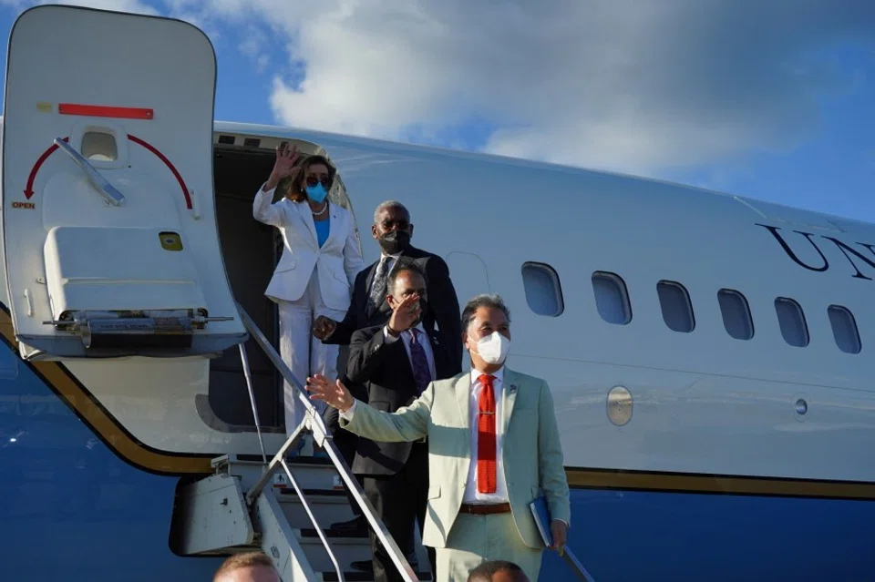 US House of Representatives Speaker Nancy Pelosi waves with other members of the delegation as they board a plane before leaving Taipei Songshan Airport, in Taipei, Taiwan, 3 August 2022. (Taiwan Ministry of Foreign Affairs/Handout via Reuters)