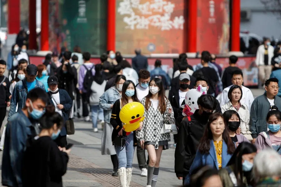 People visiting a business street in Shenyang, Liaoning province on 4 May 2021. (STR/AFP)