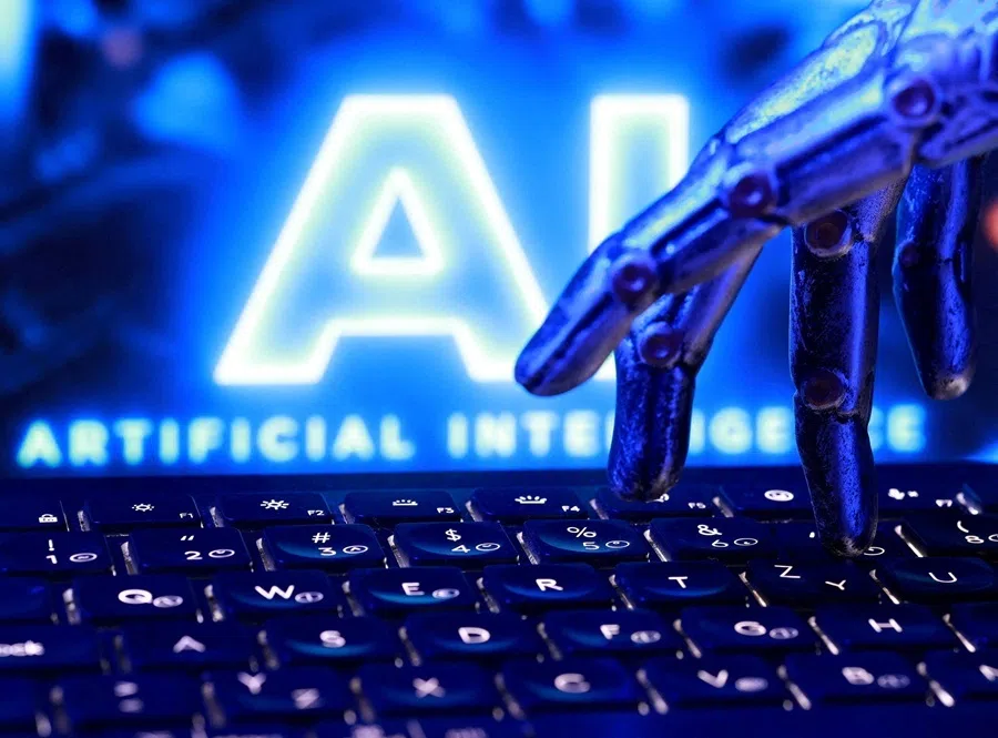 "AI Artificial Intelligence" words, a keyboard and a robotics hand in this illustration taken, 23 September 2026.