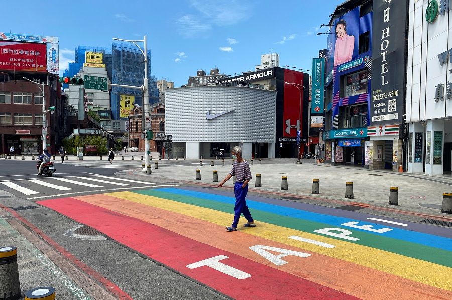 A man crossing the road at Ximending shopping area in Taipei's Wanhua district, Taiwan on 28 May 2021. (Ben Blanchard/Reuters)