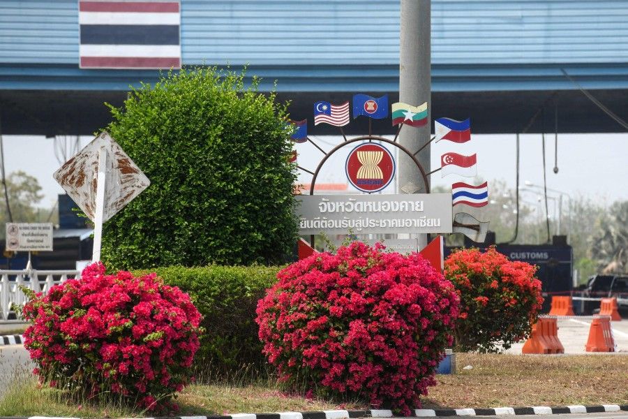 This picture taken on 16 March 2021 shows a sign showcasing the countries in the Association of Southeast Asian Nations (ASEAN) at the border between Thailand and Laos, as seen from the northern Thai region of Nong Khai. (Panumas Sanguanwong/AFP)