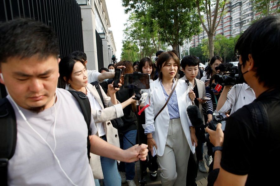 Xu Zaozao walks outside the No. 3 Intermediate People's Court after a court hearing of her suit against a Beijing hospital for rejecting her request to freeze her eggs on the grounds that she is unmarried, in Beijing, China, 9 May 2023. (Florence Lo/Reuters)