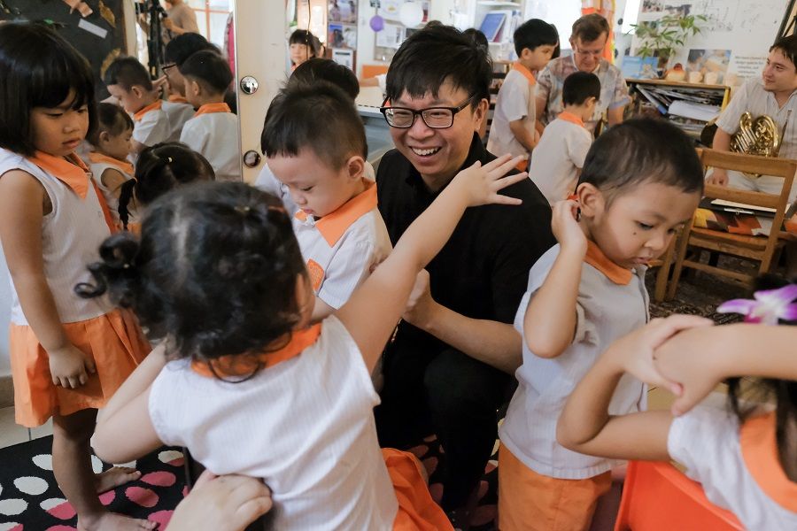 Singaporean conductor Wong Kah Chun with students from Child at Street 11 as part of Project Infinitude. (Photo: Child at Street 11/Wong Kah Chun)