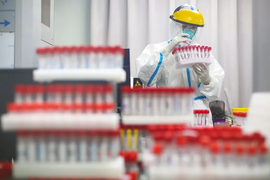 A medical staff in protective suit works at a nucleic acid testing laboratory of Nanjing First Hospital in Nanjing, Jiangsu province, China, 24 July 2021. (CNS photo via Reuters)