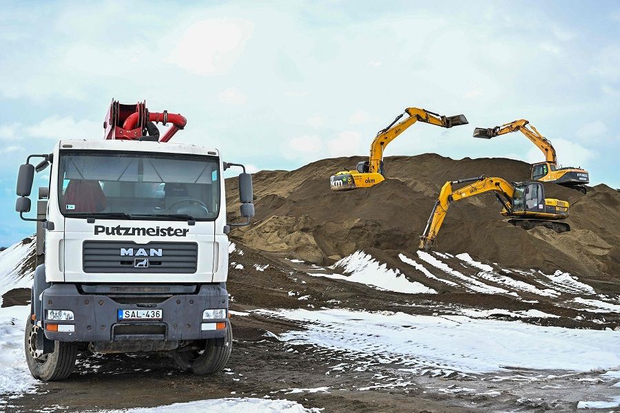 Excavators and a truck are seen at work in the industrial area near Debrecen, 230 km east of Budapest, Hungary, on 4 February 2023 to prepare the construction of a battery factory by Chinese battery giant CATL. (Attila Kisbenedek/AFP)