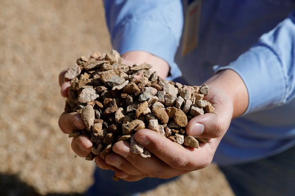 A mining/crushing supervisor at MP Materials displays crushed ore before it is sent to the mill at the MP Materials rare earth mine in Mountain Pass, California, 30 January 2020. (Steve Marcus/File Photo/Reuters)