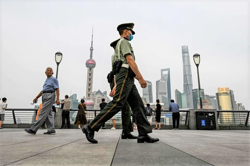 Chinese paramilitary police walk on the Bund promenade along the Huangpu river in the Huangpu district in Shanghai, China, on 15 June 2023. (Hector Retamal/AFP)