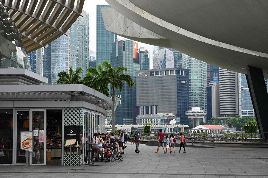 People sit outside a restaurant at the Marina Bay Sands mall in Singapore on 3 January 2022. (Roslan Rahman/AFP)